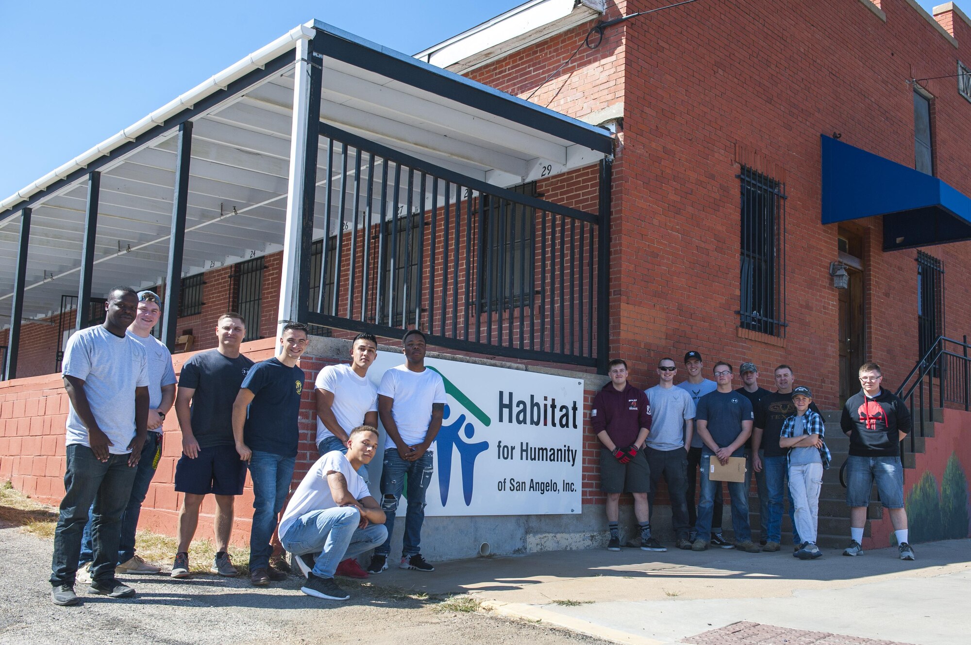 Members of the 17th Communications Squadron pose for a group photo outside of the Habitat for Humanity center in San Angelo, Texas, Oct. 26, 2017. Once a month, the 17th Communications Squadron pulls together and volunteers, and for October they chose Habitat for Humanity. (U.S. Air Force photo by Senior Airman Scott Jackson/Released)