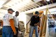 U.S. Air Force Staff Sgt. Adam Baty, 17th Communications Squadron client systems technician, Staff Sgt. Louis Perry, 17th CS client systems technician, and a Habitat for Humanity volunteer, go over plans for their volunteer day for HFH center in San Angelo, Texas, Oct. 26, 2017. 17th CS spent most of the day reorganizing and preparing HFH for a fundraising event. (U.S. Air Force photo by Senior Airman Scott Jackson/Released)