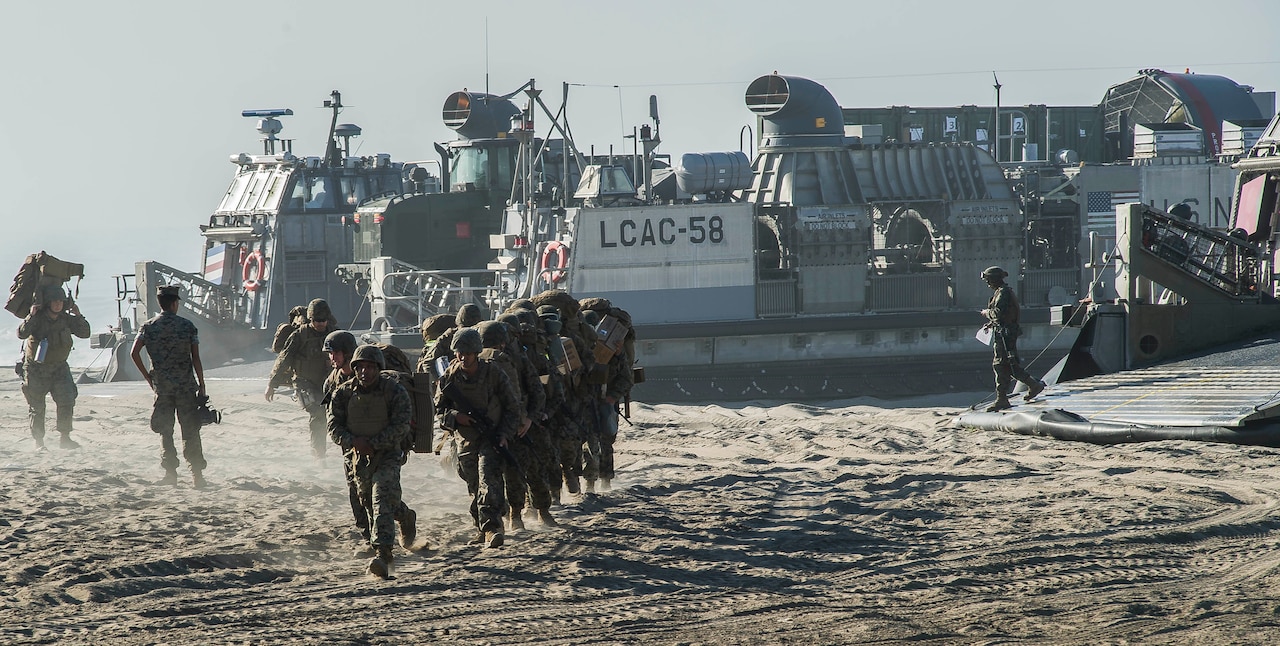 Marines disembark from an air-cushioned landing craft to begin the Red Beach tactical maneuvering.