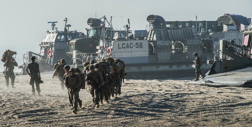 Marines disembark from an air-cushioned landing craft to begin the Red Beach tactical maneuvering.