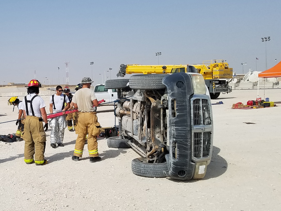 Air Force firefighters in Qatar practice their extrication skills using a vehicle obtained from DLA Disposition Services.