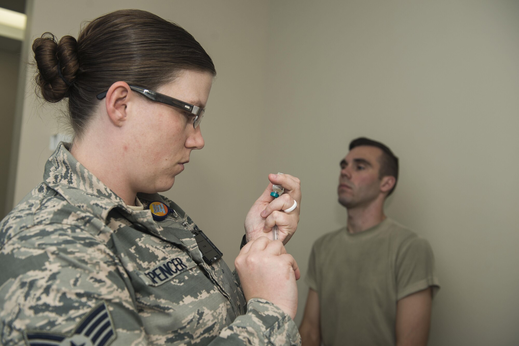 U.S. Air Force Staff Sgt. Jake Spencer, 20th Medical Operations Squadron immunizations backup technician, prepares a vaccine for Capt. Adam Gadson, 20th Logistics Readiness Squadron operations officer, at Shaw Air Force Base, South Carolina, Oct. 23, 2017.
