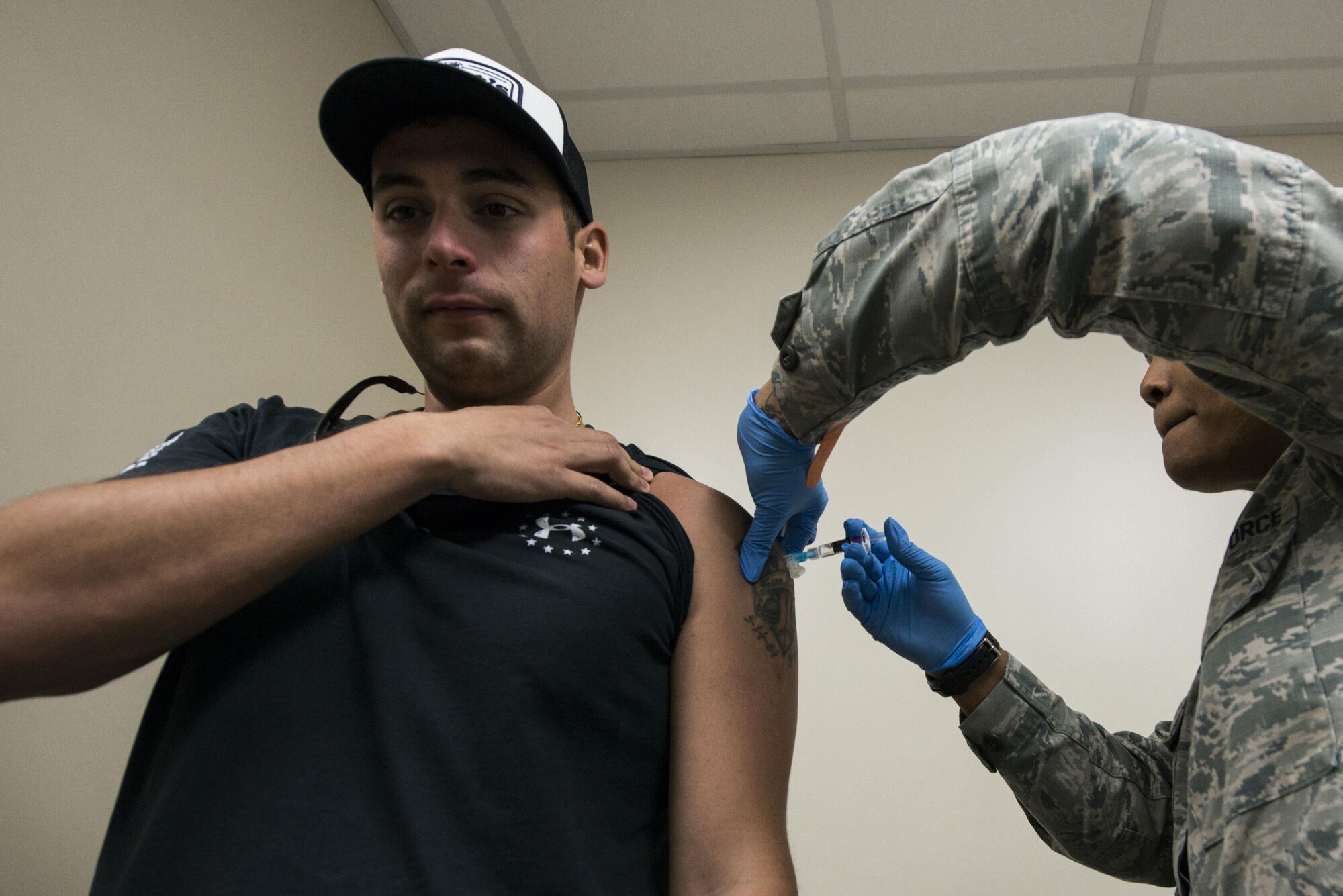 U.S. Air Force Staff Sgt. Jordan Herrick, 20th Civil Engineer Squadron firefighter, receives a vaccine from Senior Airman Tamika Bradley, 20th Medical Operations Squadron allergy and immunizations technician, at Shaw Air Force Base, South Carolina, Oct. 23, 2017.