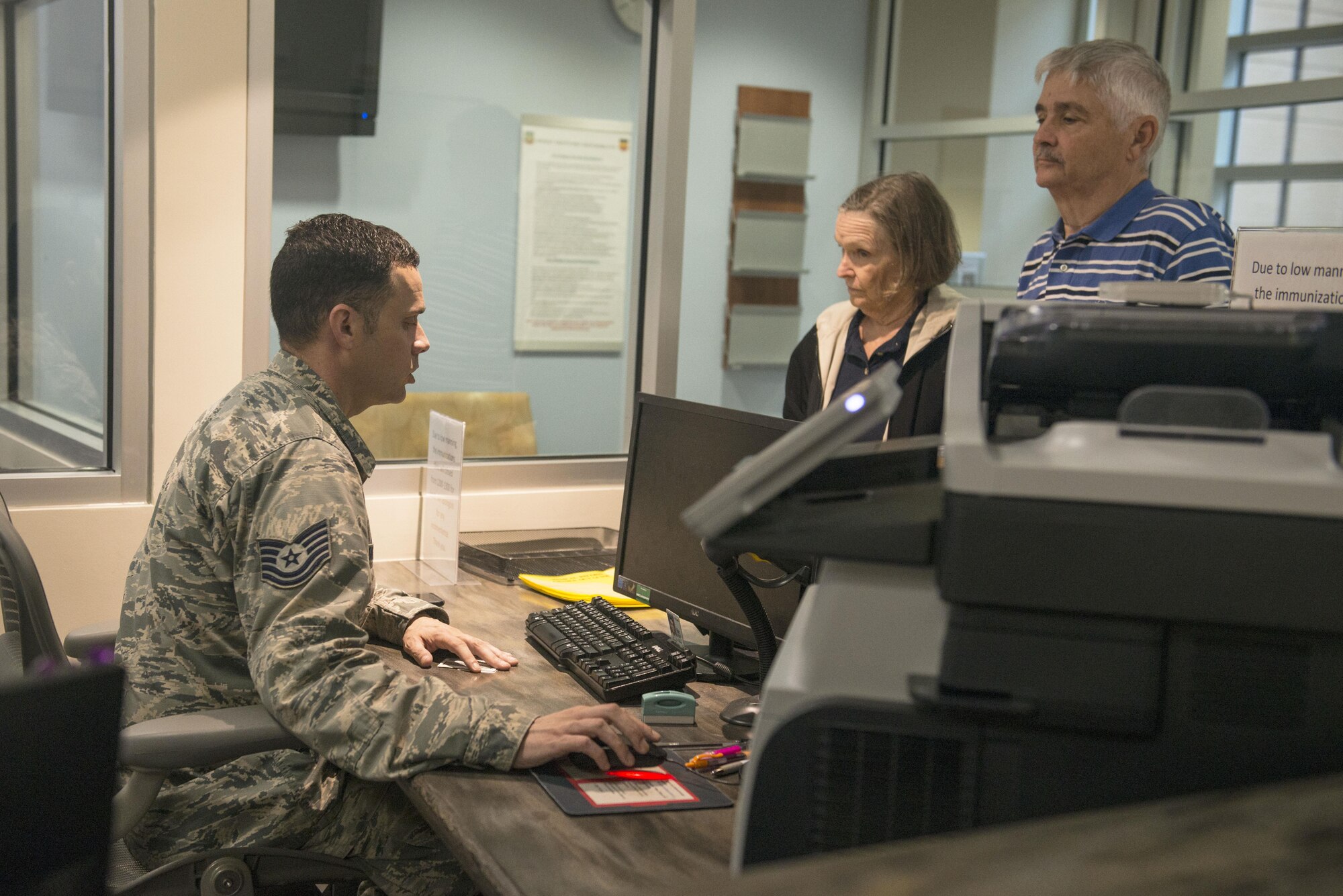 U.S. Air Force Tech. Sgt. Richard Sangston, 20th Medical Operations Squadron immunizations clinic noncommissioned officer in charge, helps patients at the front desk of the immunizations clinic at Shaw Air Force Base, South Carolina, Oct. 23, 2017.