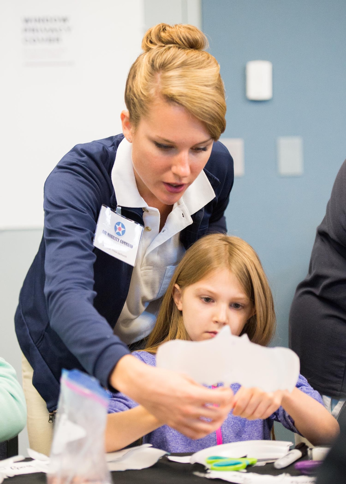 Tricia Upchurch, Air Mobility Command Museum volunteer educator, helps a visiting student build a glider Oct. 17, 2017, at the Air Mobility Command Museum on Dover Air Force Base, Del.