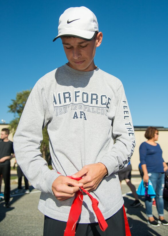 A participant of the Zombie Fun Run fastens his flag belt prior to the run Oct. 27, 2017, at Dover Air Force Base, Del.