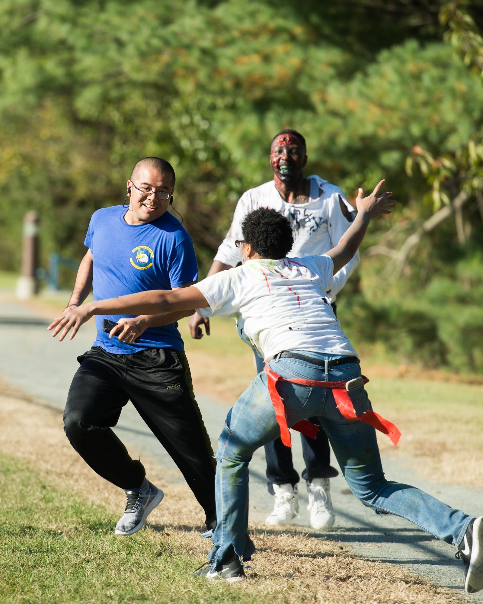 A participant narrowly escapes capture during the 2017 Zombie Fun Run Oct. 27, 2017, at Dover Air Force Base, Del. Over 200 runners participated in the event. (U.S. Air Force photo by Mauricio Campino)