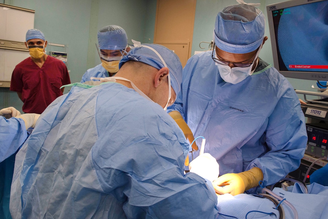 Sailors perform surgery in an operating room aboard the hospital ship USNS Comfort.