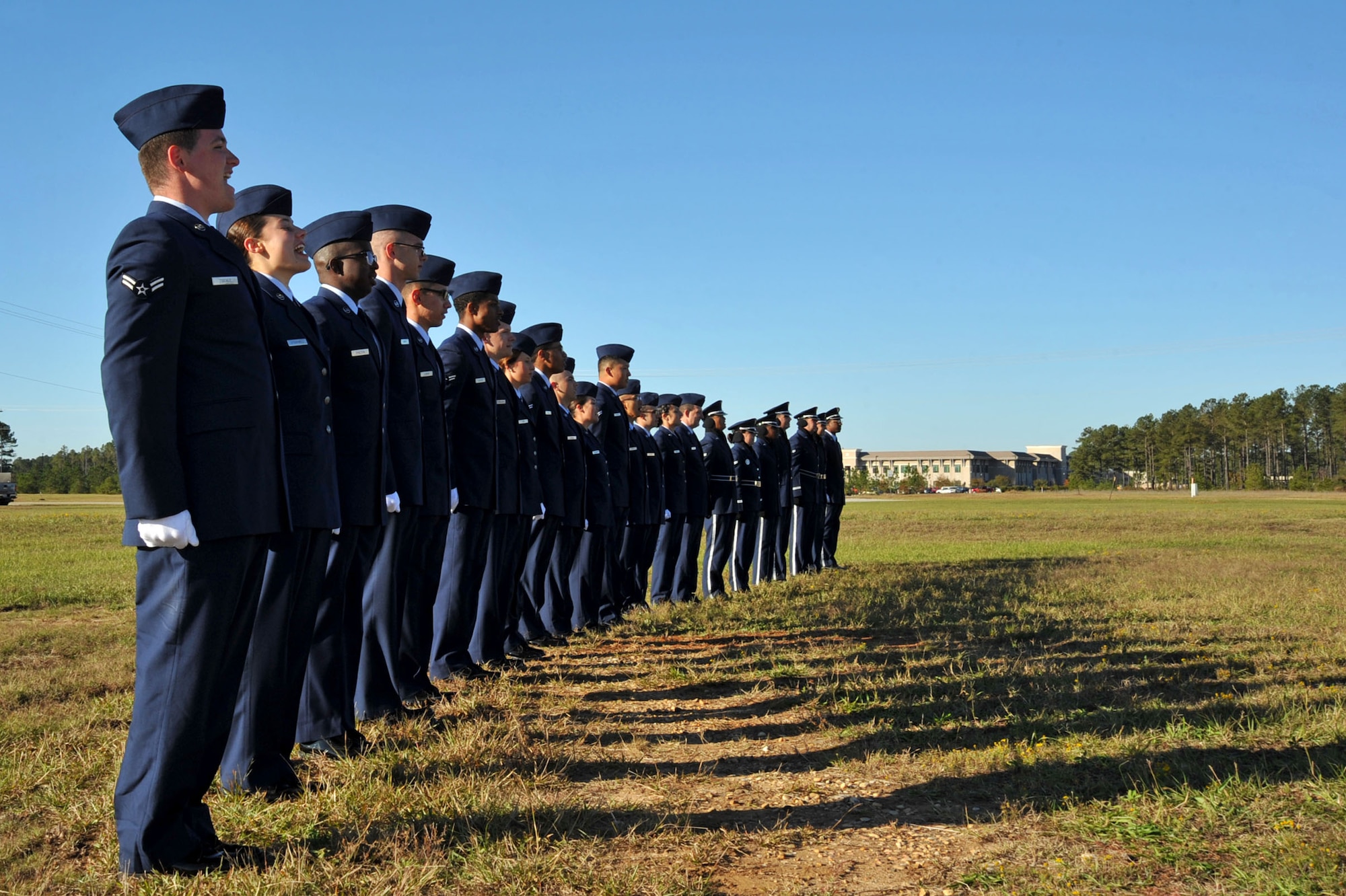 U.S. Airmen temporarily assigned to the 20th Force Support Squadron Honor Guard sing the Air Force Song after an honor guard graduation at Shaw Air Force Base, South Carolina (S.C.), Oct. 30, 2017.