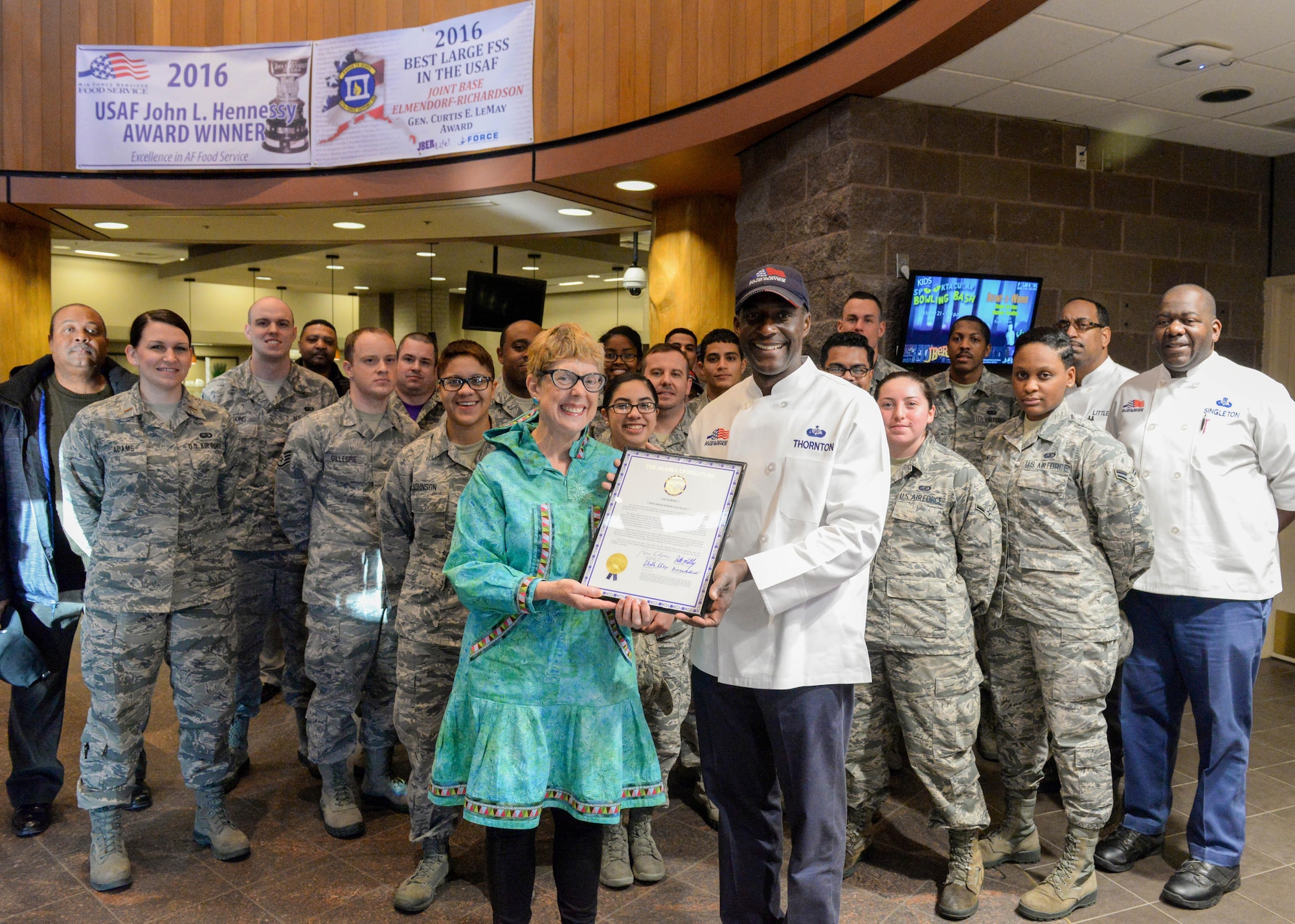 Alaska State Rep. Gabrielle LeDoux presents the Iditarod Dining Facility with a legislative citation at Joint Base Elmendorf-Richardson, Alaska Oct. 20, 2017.  The citation was presented to recognize and congratulate the crew for receiving the 2016 United States Air Force John L. Hennessy Award.