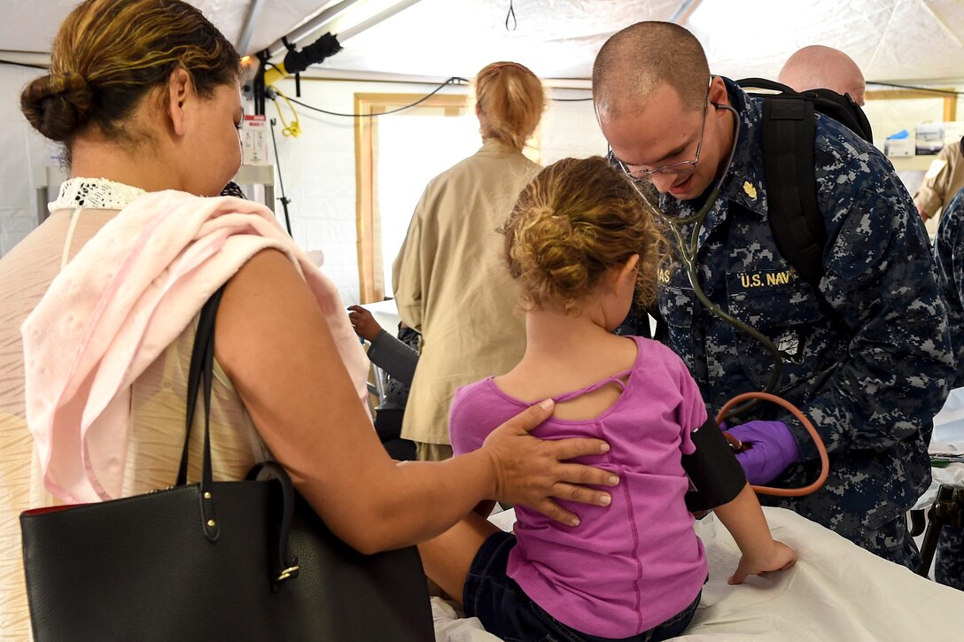A Navy doctor treats a child in Puerto Rico.
