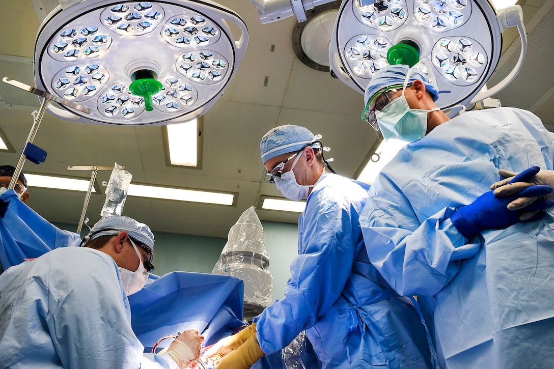 Sailors perform surgery in an operating room aboard the hospital ship USNS Comfort.