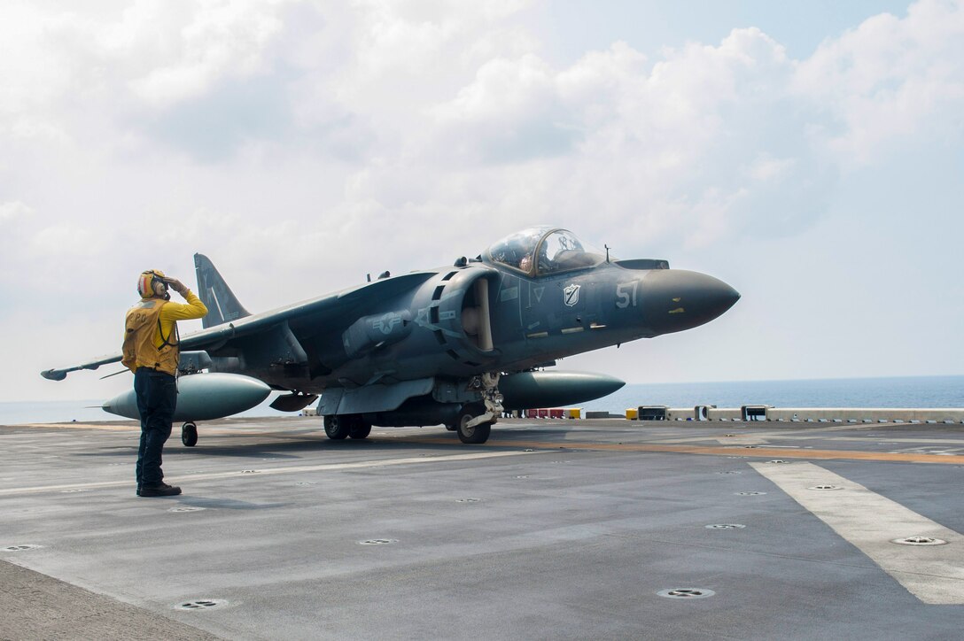 171029-N-ZS023-020 5TH FLEET AREA OF OPERATIONS (Oct. 29, 2017) Aviation Boatswain’s Mate (Handling) 2nd Class Anthony Kolm, a native of Longmont, Colorado, assigned to the air department aboard the amphibious assault ship USS America (LHA 6), salutes an AV-8B harrier assigned to Marine Medium Tiltrotor Squadron (VMM) 161 (Reinforced), on the flight deck before takeoff during flight operations. America is the flagship for the America Amphibious Ready Group and, with the embarked 15th Marine Expeditionary Unit, is deployed to the U.S. 5th Fleet area of operations in support of maritime security operations to reassure allies and partners and preserve the freedom of navigation and the free flow of commerce in the region. (U.S. Navy photo by Mass Communication Specialist Seaman Vance Hand/Released)