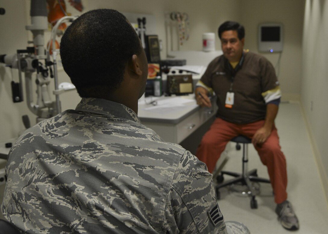 From right, Dr. William Velardi, 633rd Aerospace Medicine Squadron optometrist, assesses a patient’s eye health at Joint Base Langley-Eustis, Va., Oct. 3, 2017.