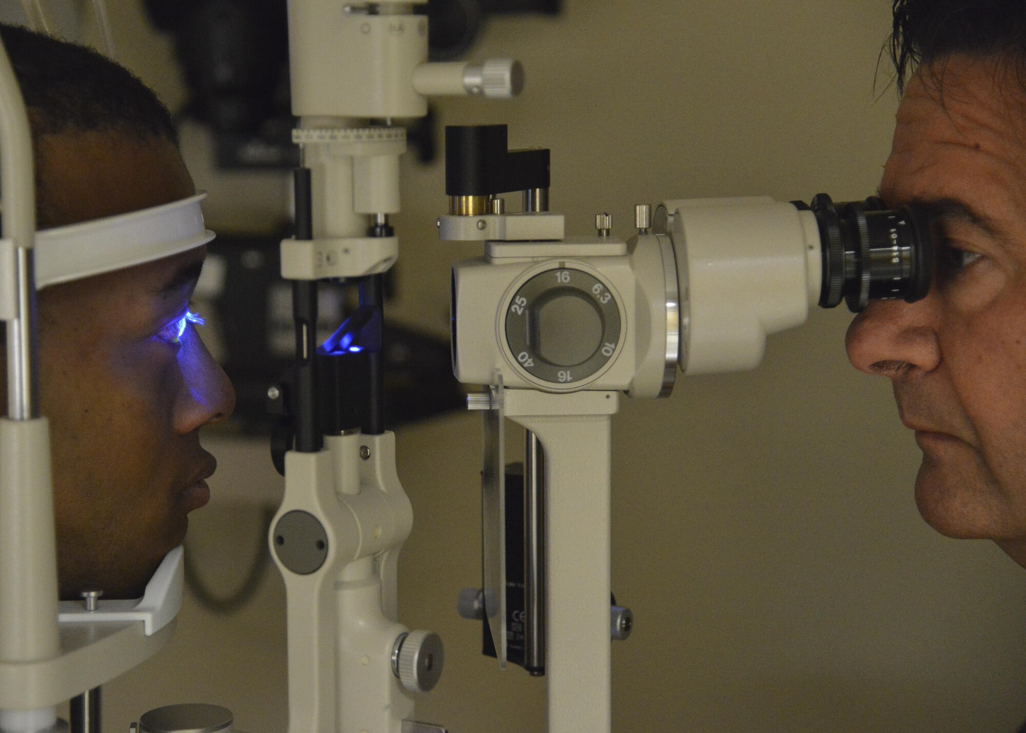 From right, Dr. William Velardi, 633rd Aerospace Medicine Squadron optometrist, checks a patient’s eyes at Joint Base Langley-Eustis, Va., Oct. 3, 2017.