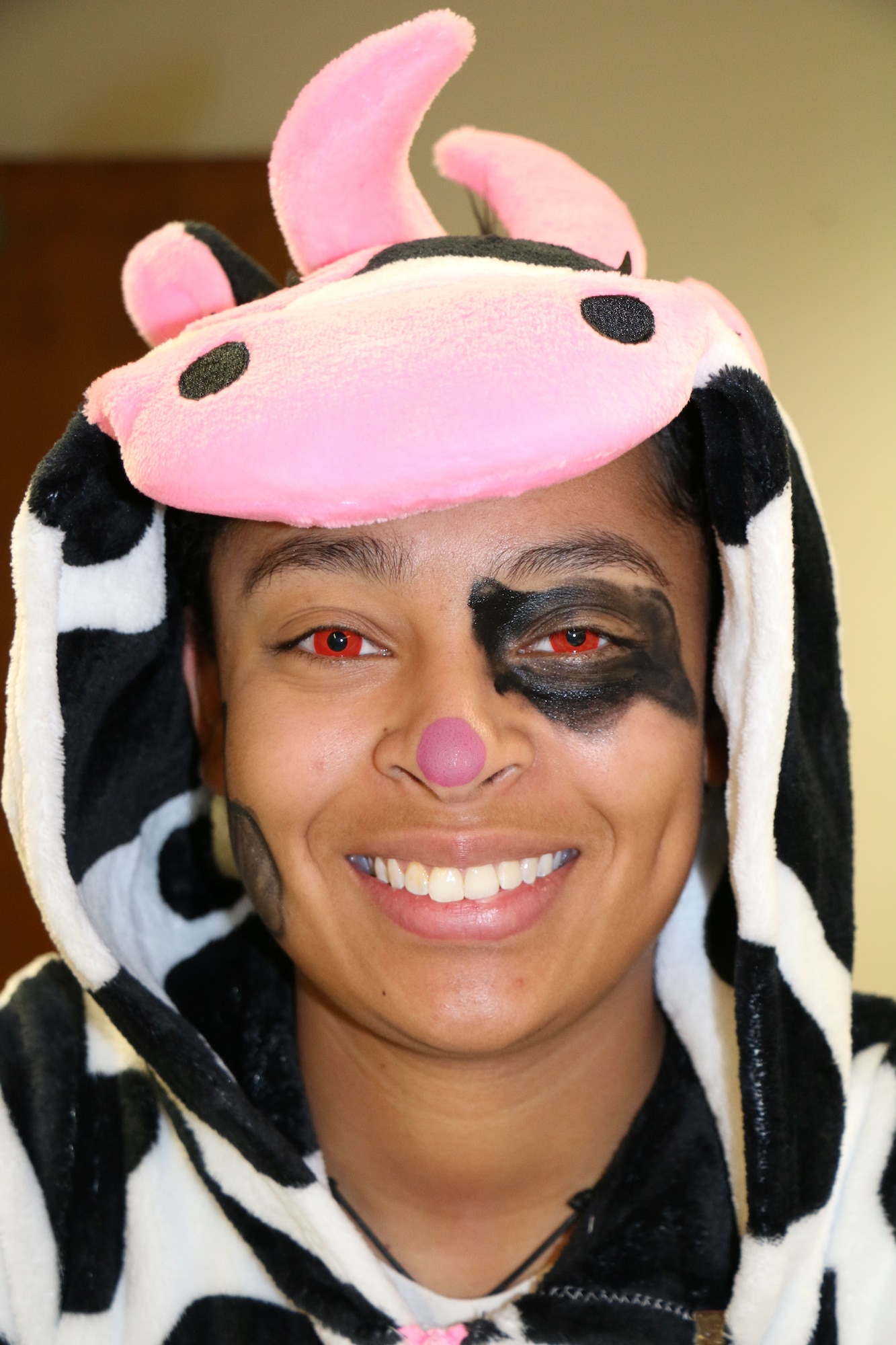 Senior Airman Aleena Gomez, 21st Medical Group diagnostic imaging technologist, works while dressed as a "mad cow" Oct. 31, 2017 at Peterson Air Force Base, Colorado. (U.S. Air Force photo by Staff Sgt. Erica Picariello)
