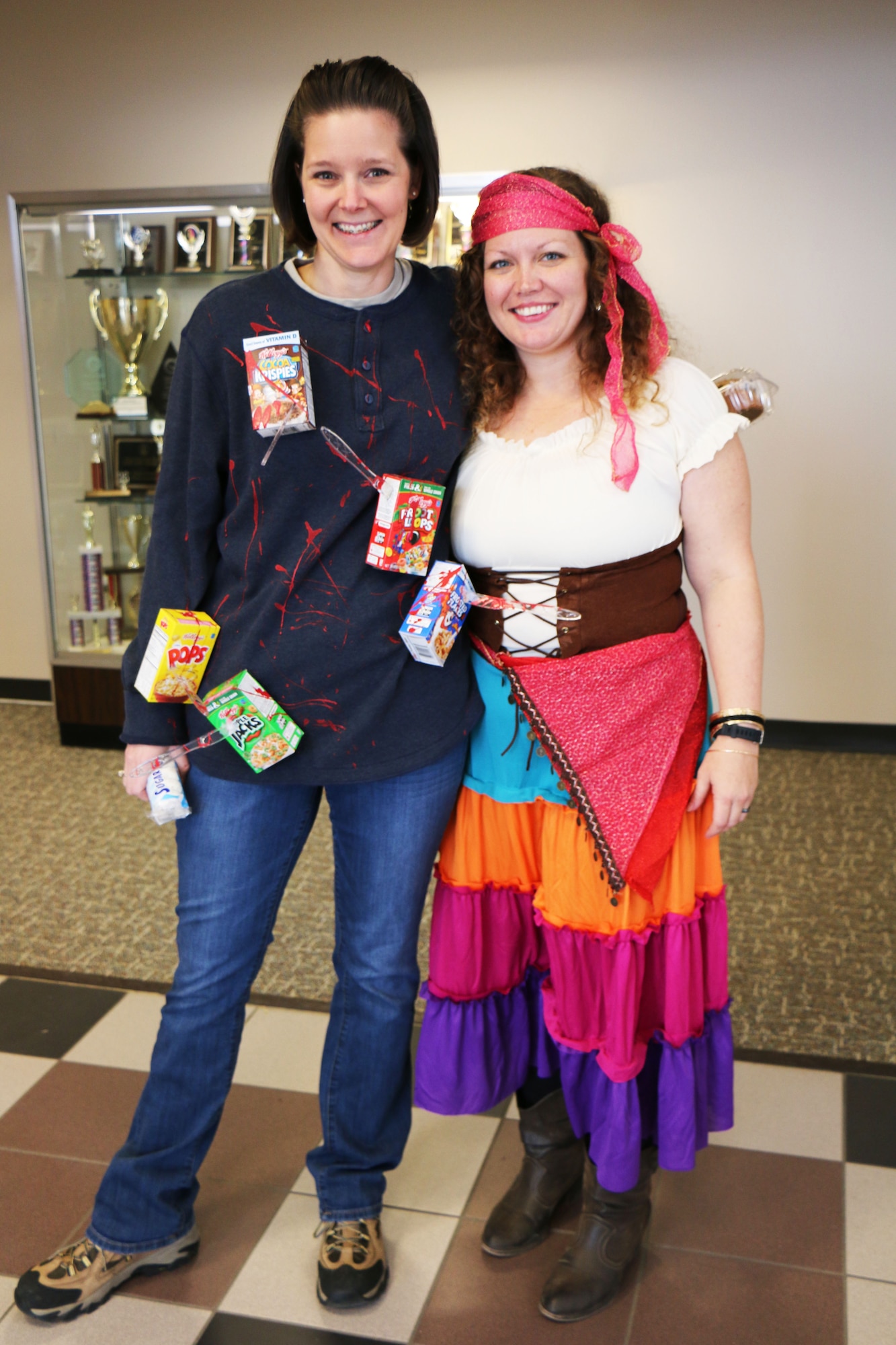 Maser Sgt. Michelle James, 21st Comptroller Squadron finance flight chief "cereal killer," poses with 2nd Lt. Danielle Sease, 21st Comptroller Squadron finance flight commander "gypsy" inside of the 21st Mission Support Group building Oct. 31, 2017 at Peterson AFB. Members were encouraged to dress in costume to celebrate Halloween. (U.S. Air Force photo by Staff Sgt. Erica Picariello)