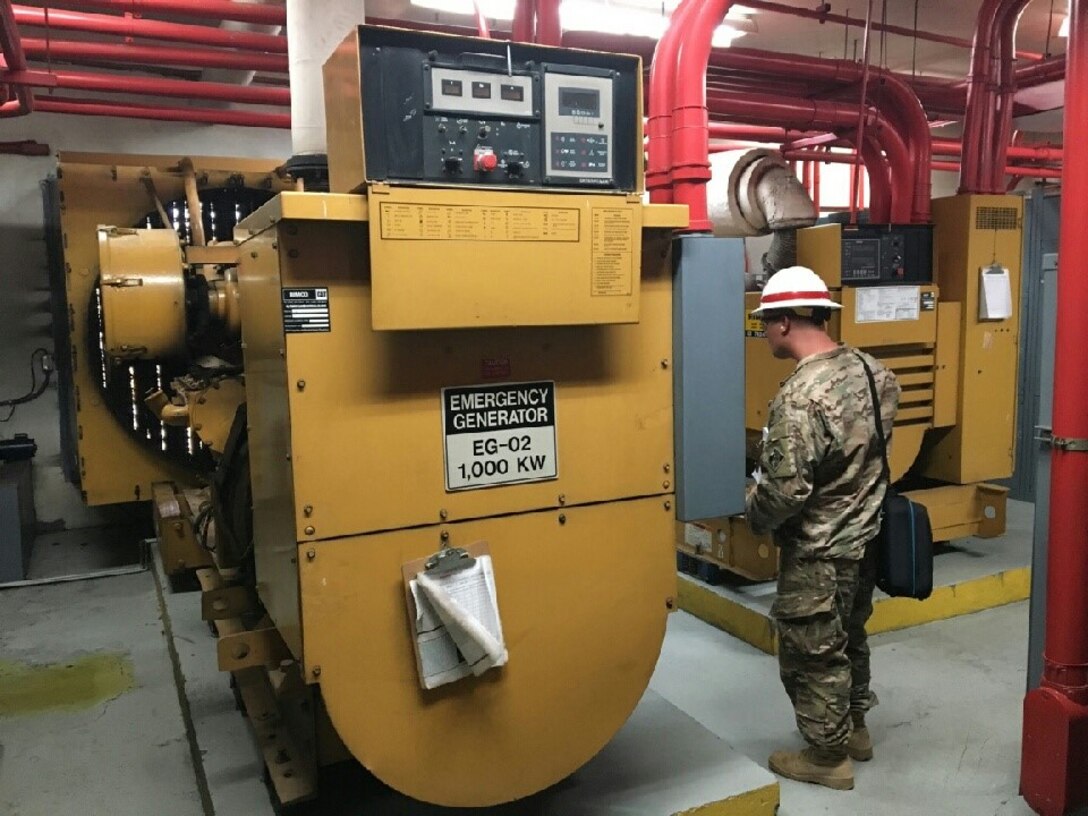 A prime power specialist assigned to 249th Engineer Battalion records information from a recently installed generator.