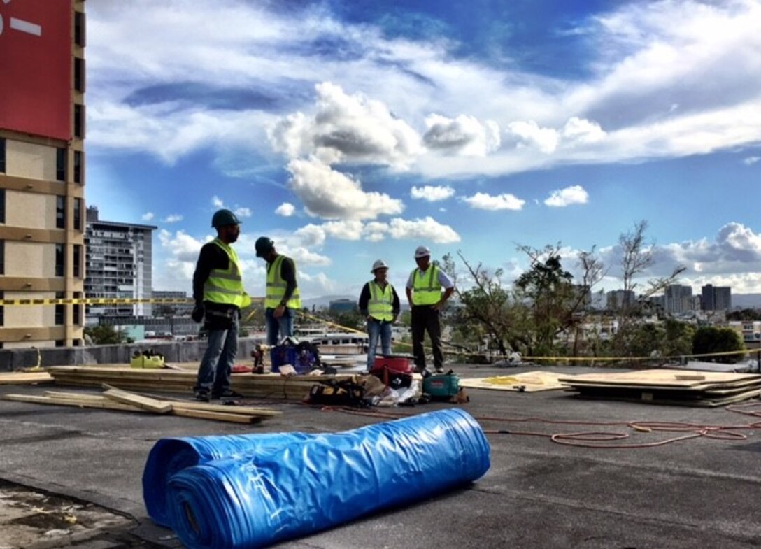 A team installs a Blue Roof on a hospital in San Juan, Puerto Rico. The temporary roof opened up several more bed in the hospital that had been closed off because of the roof damage.