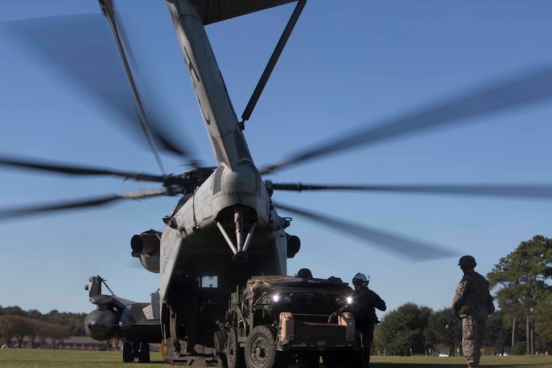 Marines with 1st Battalion, 10th Marine Regiment load a vehicle onto a CH-53 Super Stallion before a live-fire artillery exercise as part of Exercise Bold Alligator at Camp Lejeune, N.C. Oct. 23, 2017. Bold Alligator is designed to showcase the capabilities of the Navy-Marine Corps team and demonstrate cohesion with allied nations through integrated training. The U.S. Marines and British troops gained camaraderie through integrated training, allowing them to familiarize themselves with each other’s capabilities. (U.S. Marine Corps photo by Pfc. Nicholas Guevara)