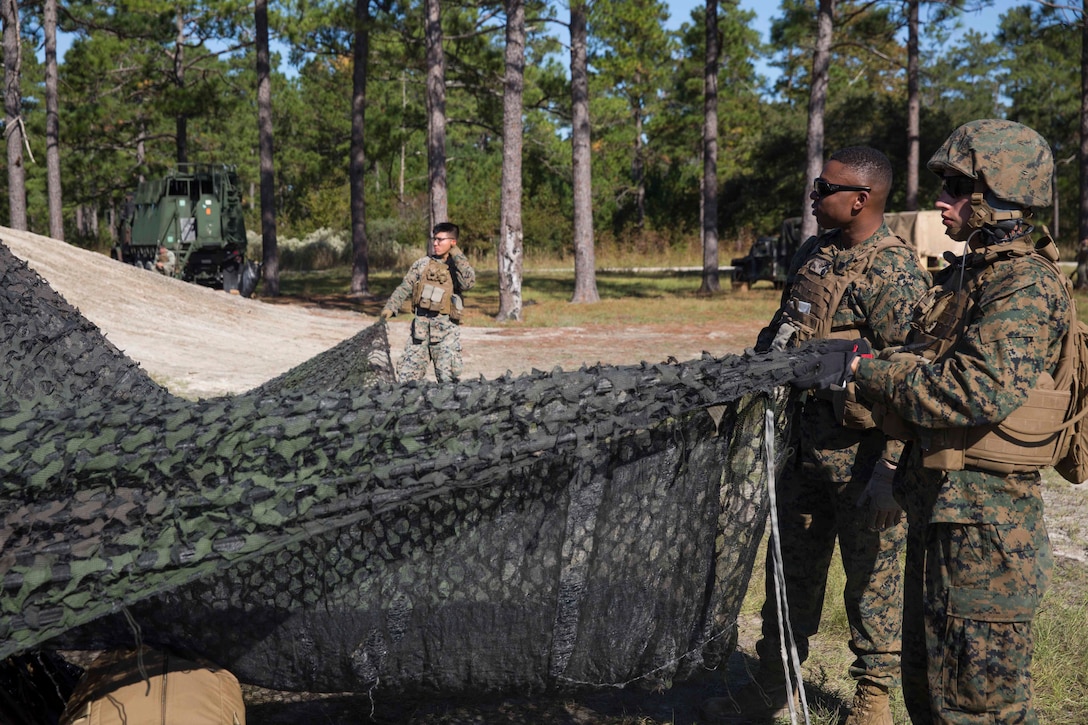 Marines use camouflage net to conceal their vehicles during a life-fire artillery exercise as part of Exercise Bold Alligator at Camp Lejeune, N.C. Oct. 23, 2017. Bold Alligator is designed to showcase the capabilities of the Navy-Marine Corps team, and demonstrate our cohesion with allied nations. The U.S. Marines and British troops gained camaraderie through integrated training, allowing them to familiarize themselves with each other’s capabilities. (U.S. Marine Corps Photo by Pfc. Nicholas Guevara)