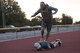 An Airman from the 366th Civil Engineer explosive ordnance disposal unit jumps over his partner and launches into a burpee at the EOD memorial workout Sept. 29, 2017, at Mountain Home Air Force Base, Idaho. The workout was performed in remembrance of all the EOD technicians who lost their lives after Sept. 11, 2001. (U.S. Air Force photo by Airman 1st Class Alaysia Berry)