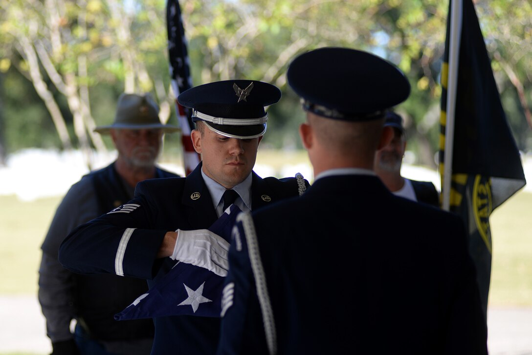 Keesler Air Force Base Honor Guard members practice flag folding procedures before a funeral ceremony Oct. 26, 2017, at the Biloxi National Cemetery in Biloxi, Mississippi. The honor guard’s primary function is to support funerals, but when not performing funeral honors the honor guard team is available to post colors or perform flag folding ceremonies for most special events and retirements on base. (U.S. Air Force photo by Airman 1st Class Suzanna Plotnikov)