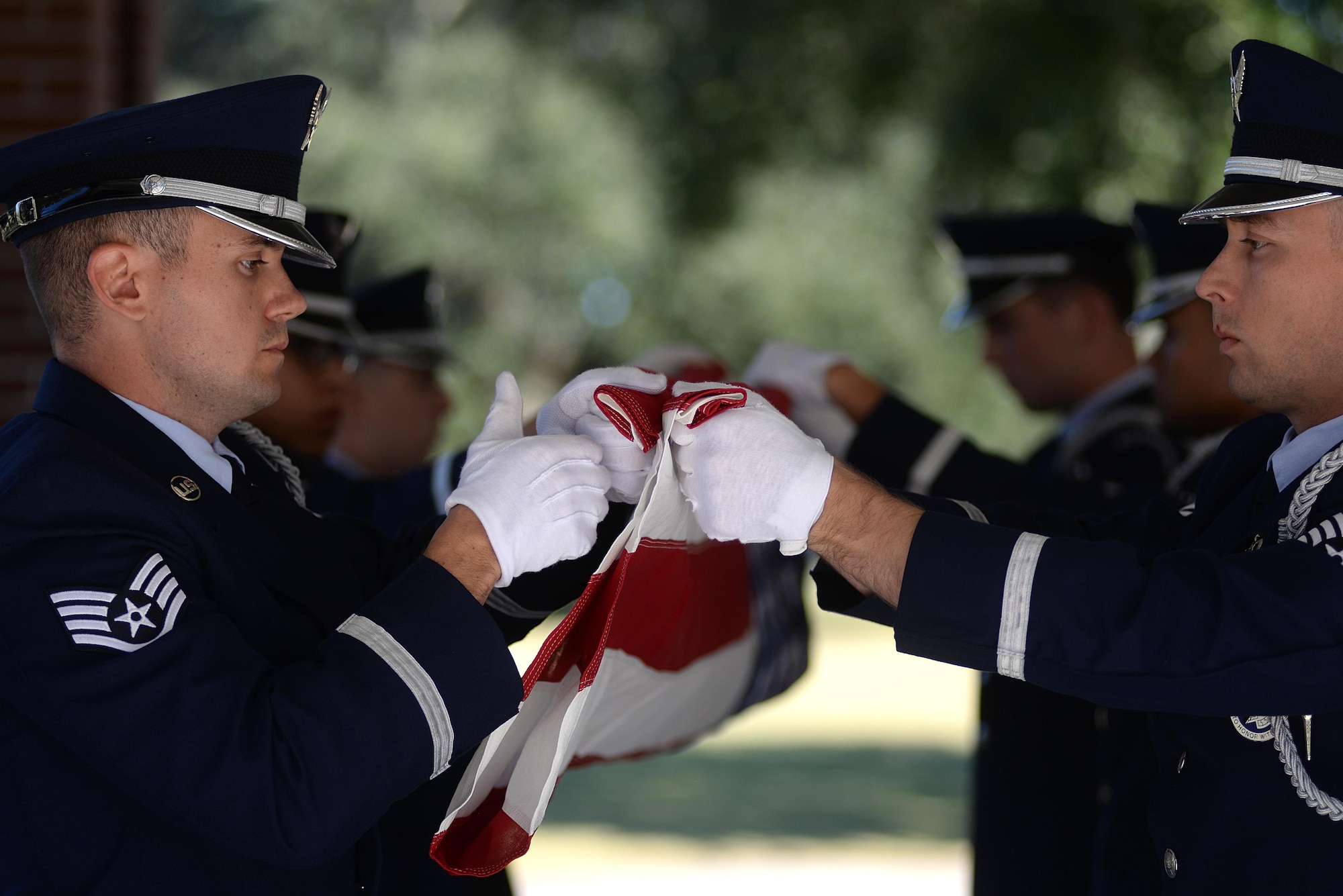 Keesler Air Force Base Honor Guard members practice flag folding procedures before a funeral ceremony Oct. 26, 2017, at the Biloxi National Cemetery in Biloxi, Mississippi. The mission of the Keesler Air Force Base Honor Guard is to represent the Air Force by providing military honors at the request of families for fallen military members. (U.S. Air Force photo by Airman 1st Class Suzanna Plotnikov)