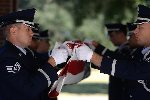 Keesler Air Force Base Honor Guard members practice flag folding procedures before a funeral ceremony Oct. 26, 2017, at the Biloxi National Cemetery in Biloxi, Mississippi. The mission of the Keesler Air Force Base Honor Guard is to represent the Air Force by providing military honors at the request of families for fallen military members. (U.S. Air Force photo by Airman 1st Class Suzanna Plotnikov)