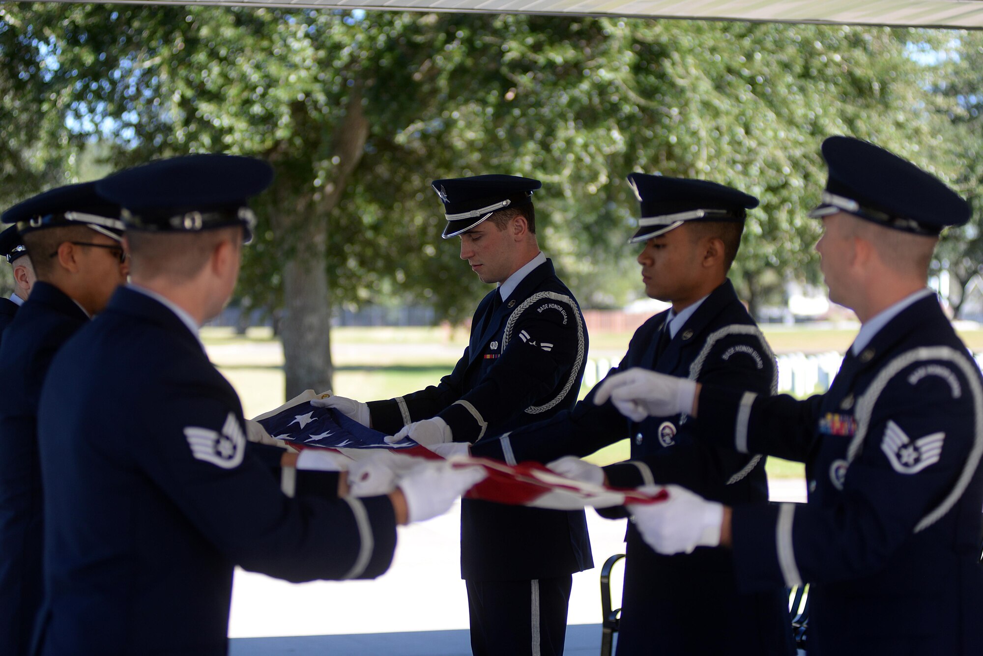 Keesler Air Force Base Honor Guard members practice flag folding procedures before a funeral ceremony Oct. 26, 2017, at the Biloxi National Cemetery in Biloxi, Mississippi. Every month the Keesler Honor Guard participates in a monthly funeral ceremony at the Biloxi National Cemetery to honor the unaccompanied remains of military members. (U.S. Air Force photo by Airman 1st Class Suzanna Plotnikov)