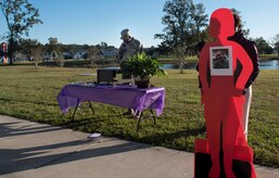 Senior Master Sgt. Derrick Sherrod, 437th Maintenance Squadron first sergeant, reads stories of fallen service members during a candlelight vigil ceremony at Joint Base Charleston, S.C., Oct. 30, 2017.