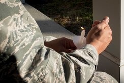 Col. Jimmy Canlas, 437th Airlift Wing commander, holds a lit candle during a moment of silence remembering all of those affected by domestic violence during a ceremony at Joint Base Charleston, S.C., Oct. 30, 2017.