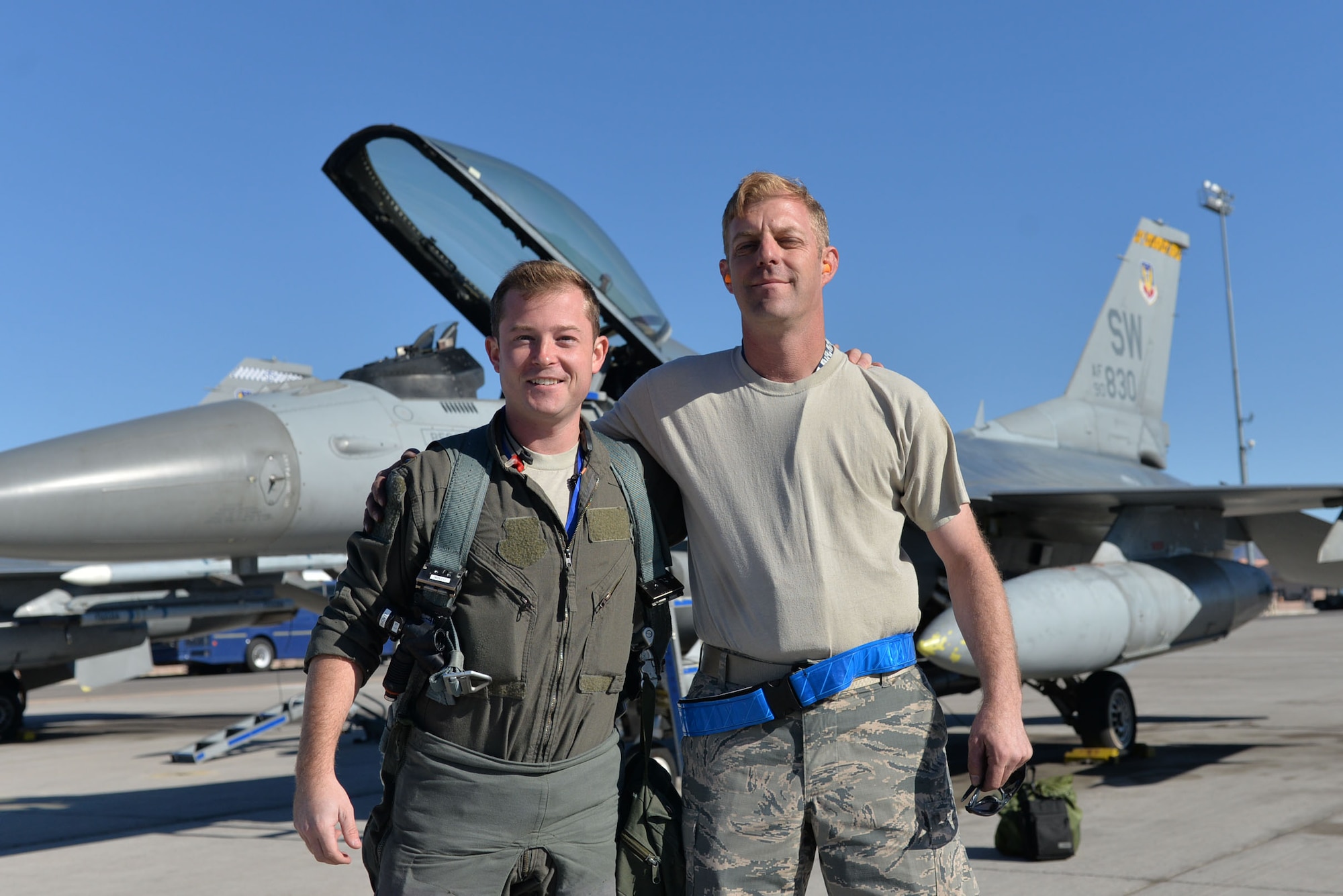 U.S. Air Force 1st Lt. Brian Davis, 55th Fighter Squadron F-16CM Fighting Falcon pilot, left, and Senior Master Sgt. Daniel Henderson, 20th Aircraft Maintenance Squadron, 55th Aircraft Maintenance Unit, “Shooters” assistant superintendent, stand next to each other in front of jet 830 for a photo prior to takeoff at Nellis Air Force Base (AFB), Nevada, Oct. 10, 2017.