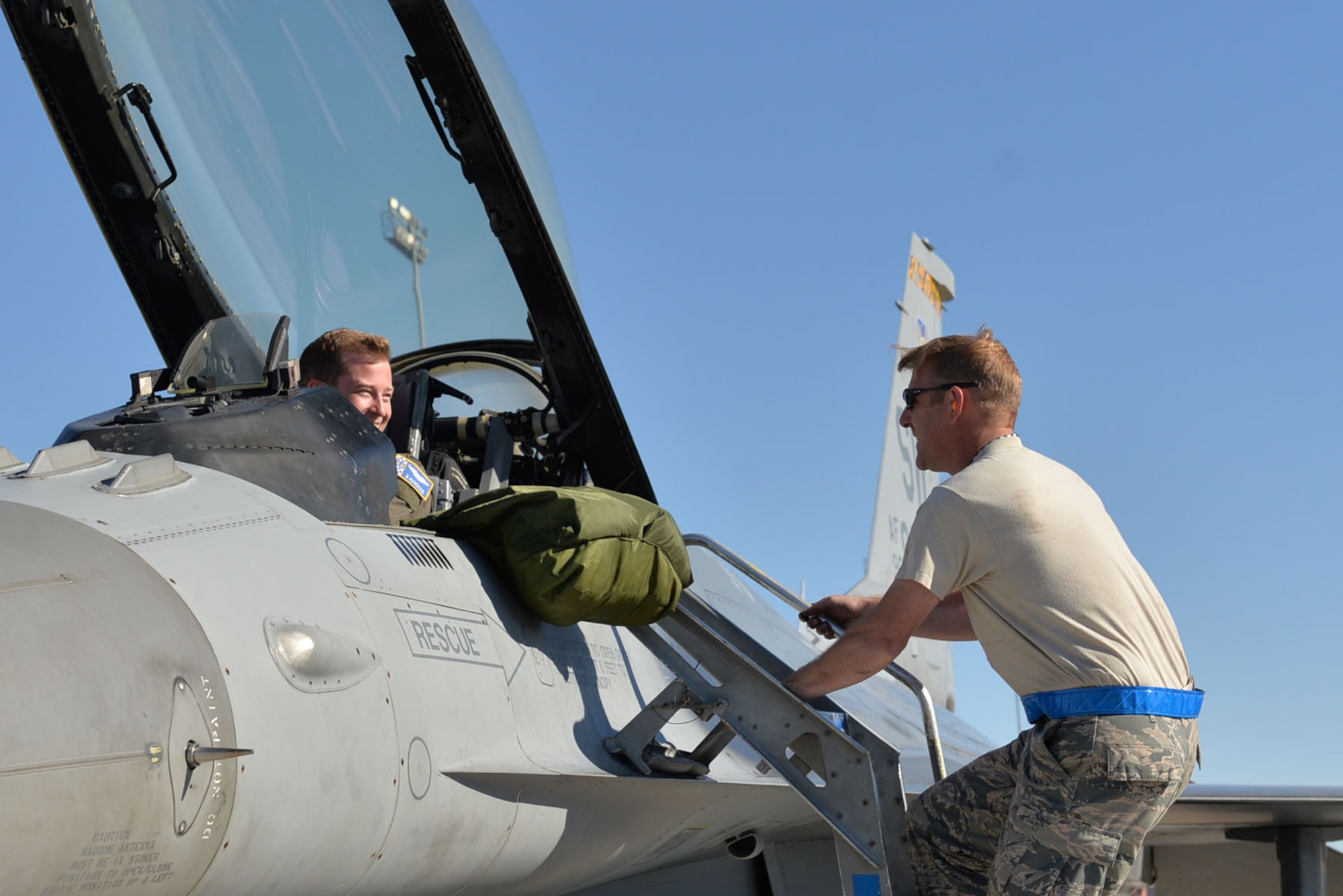 U.S. Air Force Senior Master Sgt. Daniel Henderson, 20th Aircraft Maintenance Squadron, 55th Aircraft Maintenance Unit, “Shooters” assistant superintendent, descends the ladder of an F-16CM Fighting Falcon, prior to 1st Lt. Brian Davis, 55th Fighter Squadron F-16 pilot, taking off at Nellis Air Force Base, Nevada, Oct. 10, 2017.