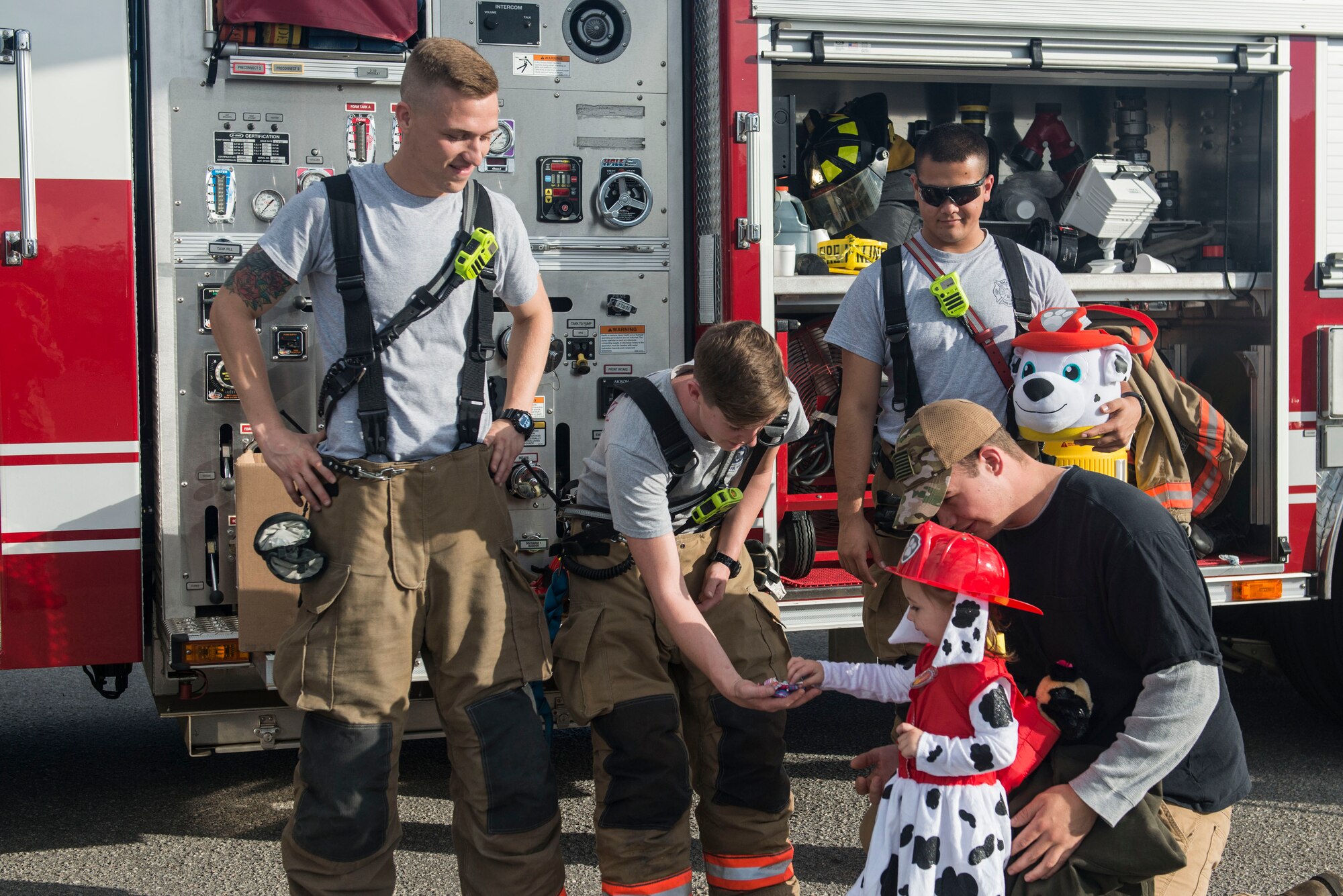 U.S. Airmen assigned to the 20th Civil Engineer Squadron fire department hand out candy to a Team Shaw child at Shaw Air Force Base, South Carolina, Oct. 28, 2017.