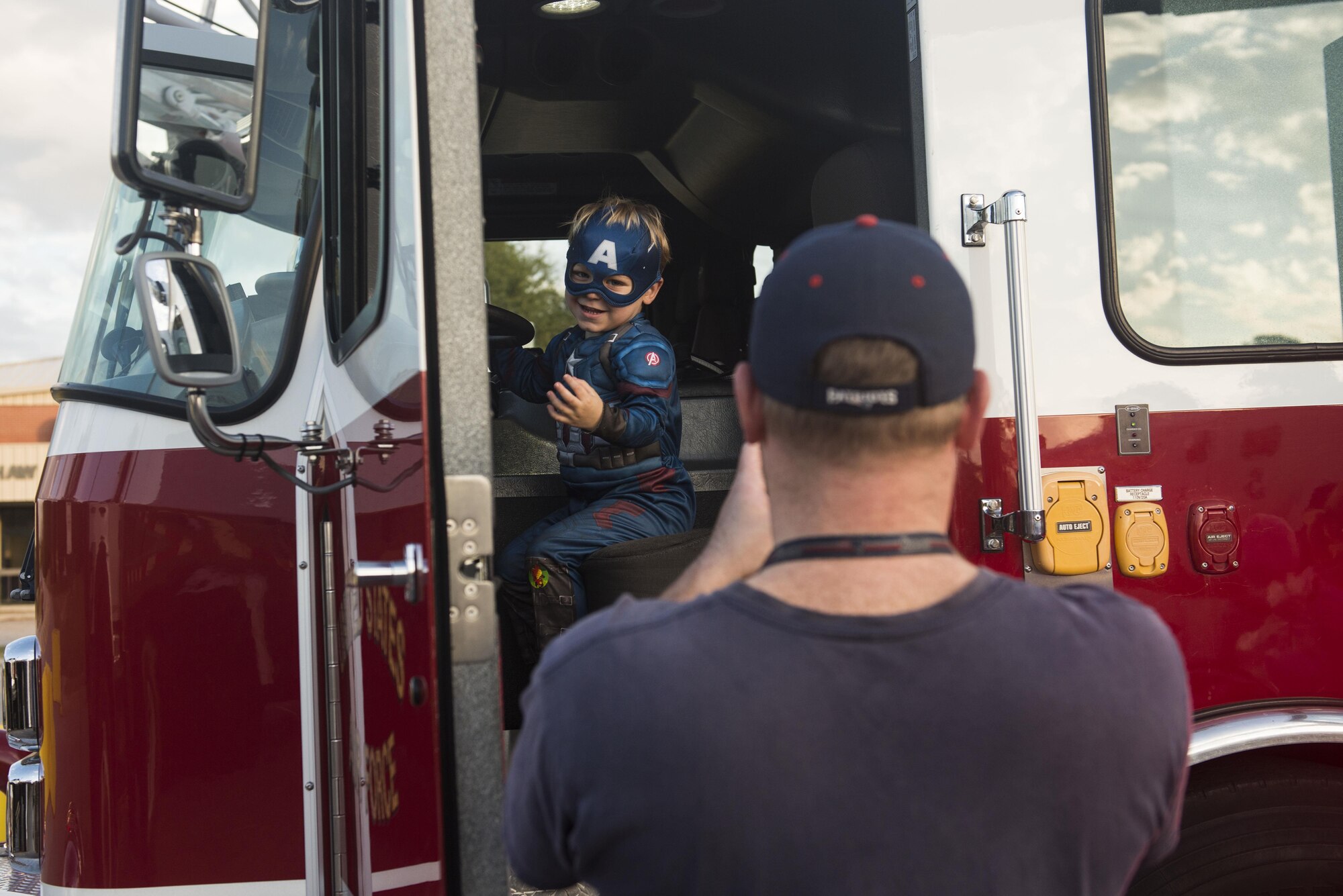 A Team Shaw member takes a picture of a child sitting in a firetruck during the ninth annual Boo Bash at Shaw Air Force Base, South Carolina, Oct. 28, 2017.