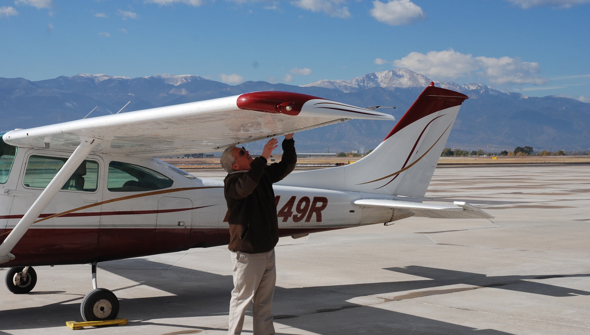 Greg Cortum, Peterson Air Force Base Aero Club/Rocky Mountain Flight Training Center manager, undertakes a preflight walk around at the club hangar on Peterson Air Force Base, Colorado on Oct. 31, 2017. The group was recognized as a 2017 Aircraft Owners and Pilots Association Training Experience Awards Distinguished Flight School. (U.S. Air Force photo by Dave Smith)