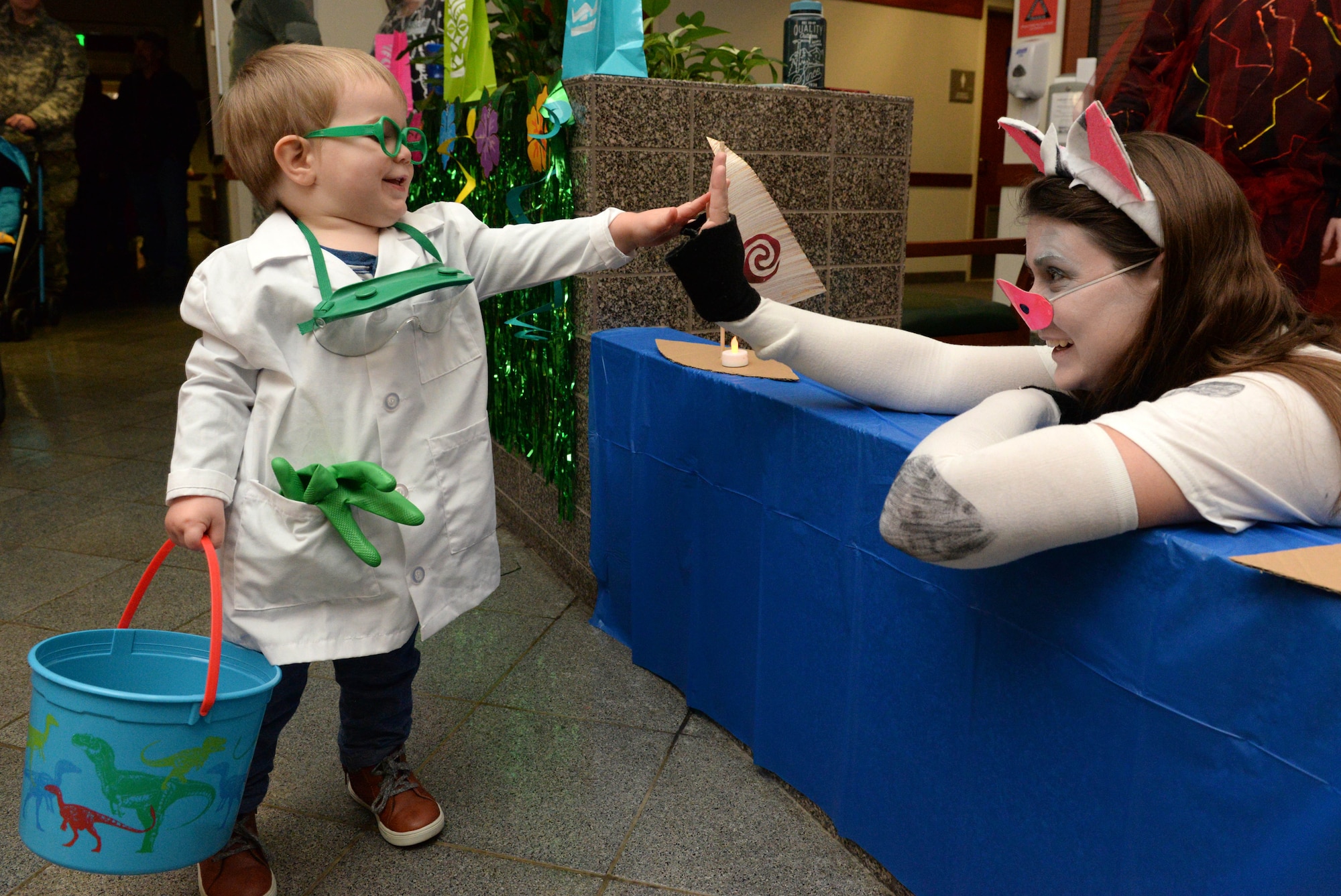 David, son of Tech. Sgt. John Jenkins, non-commissioned officer in charge, weather specialty teams, greets the 673d Medical Support Squadron Women’s Health Clinic staff member at the annual 673d Medical Group trick-or-treat event at Joint Base Elmendorf-Richardson, Alaska, Oct. 27, 2017. During this event the hospital will transform the clinic lobbies into themed stages for costumed hospital staff to pass out candy to participants on Oct. 26, 2018.