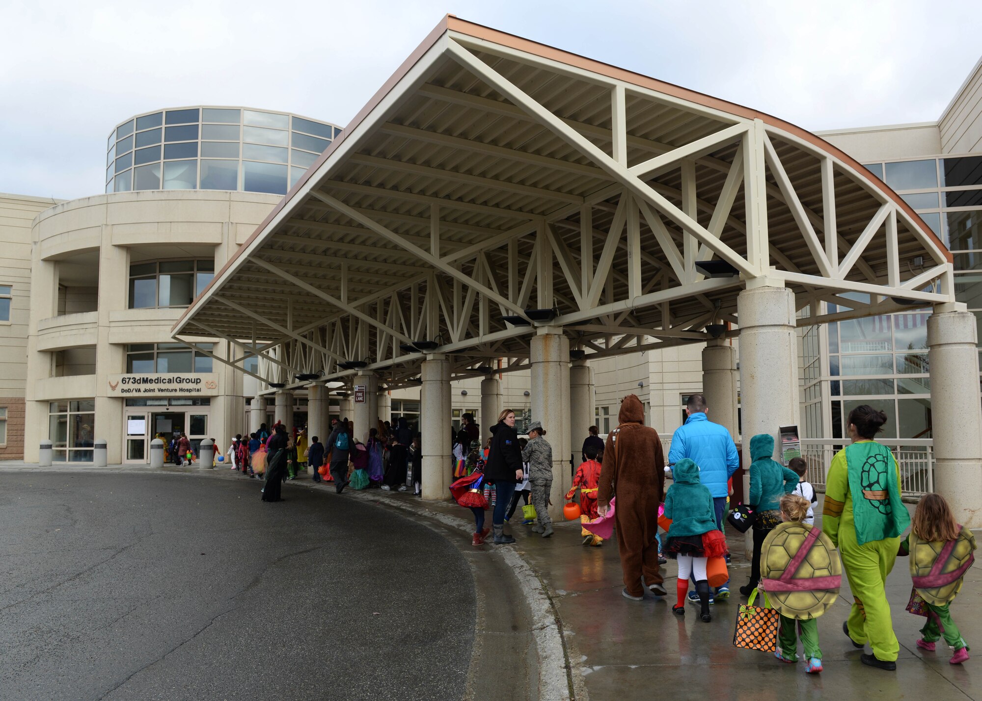 Families line up for the trick-or-treat event at the hospital on Joint Base Elmendorf-Richardson, Alaska, Oct. 27, 2017. Costumed JBER hospital workers with themes picked by their individual clinics will hand out candy to people of all ages during the annual event scheduled for Oct. 26, 2018.