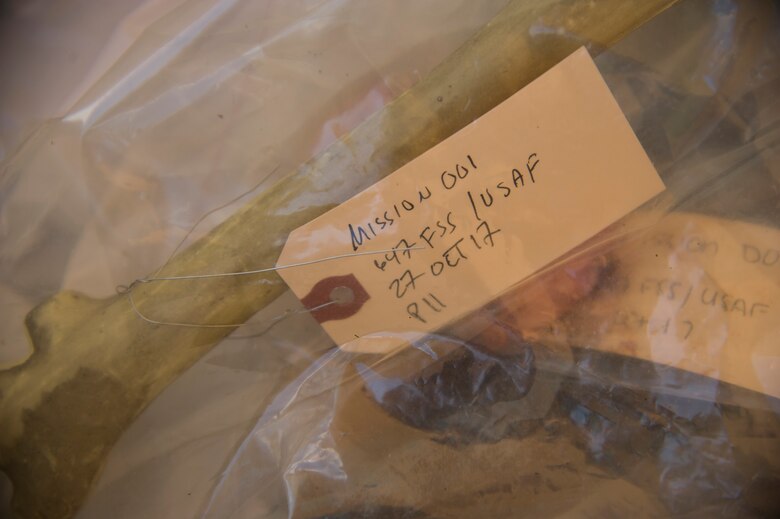 Evidence is collected at a central point during the search and recovery team’s training event on Joint Base Pearl Harbor-Hickam, Hawaii, Oct. 27, 2017. The search and recovery team is tasked with recovering human remains from accident sites. (U.S. Air Force photo by Tech. Sgt. Heather Redman)