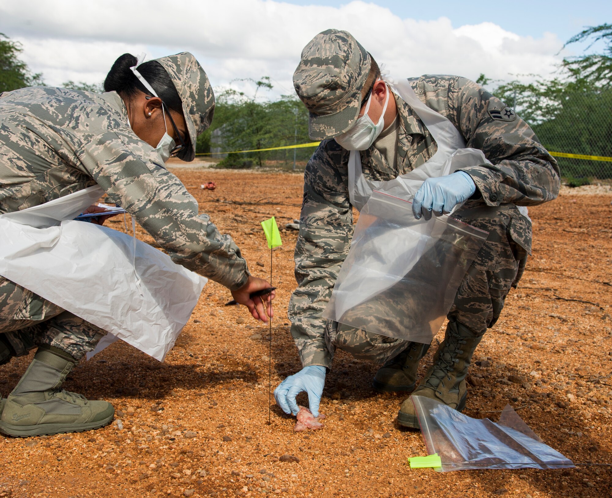 Members of the 647th Force Support Squadron search and recovery team tag and mark simulated remains during the search and recovery team’s training event on Joint Base Pearl Harbor-Hickam, Hawaii, Oct. 27, 2017. The search and recovery team is tasked with recovering human remains from accident sites. (U.S. Air Force photo by Tech. Sgt. Heather Redman)