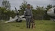 A Japan Air Self-Defense Force 3rd Air Wing security member and military working dog await orders during a security procedure exercise at Misawa Air Base, Japan, Aug. 30, 2017. In addition to the mock crash, JASDF members conducted a mock improvised explosive device exercise, perfecting entry-to-base procedures prior to the upcoming air show on Sept. 10. (U.S. Air Force photo by Staff Sgt. Deana Heitzman)