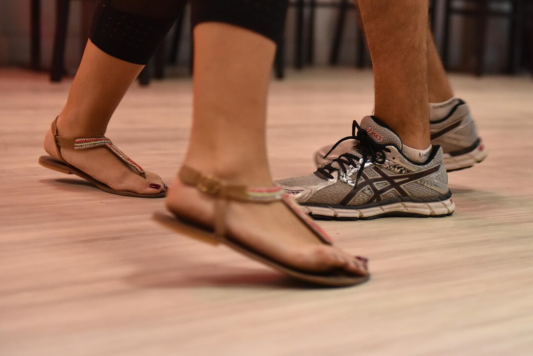 Two Airmen with the 380th Air Expeditionary Wing practice Latin dance moves at Al Dhafra Air Base, United Arab Emirates, Aug. 26, 2017.