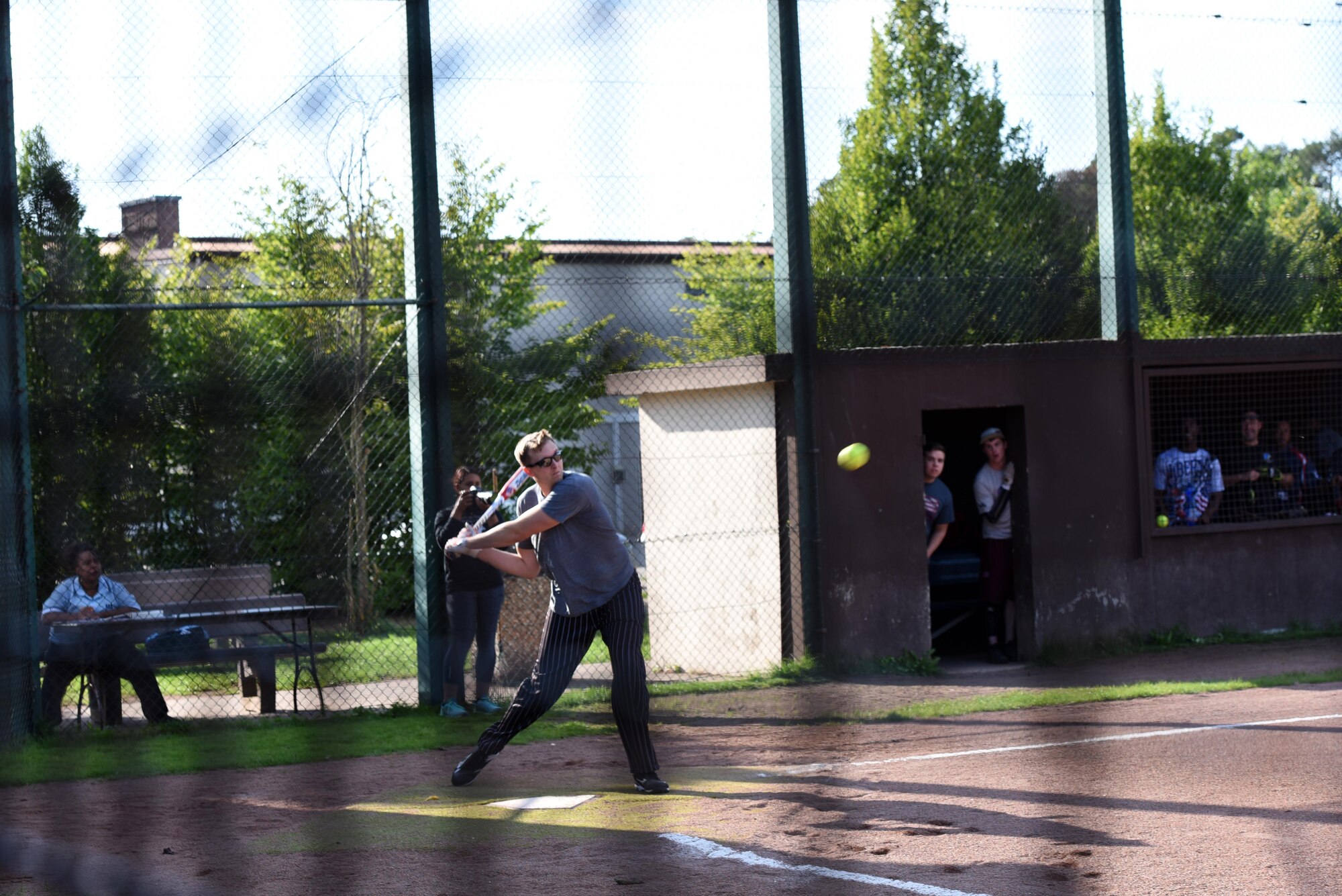 U.S. Air Force Staff Sgt. Theron Green, 86th Maintenance Squadron job title, swings at a softball during an intramural soft ball game on Ramstein Air Base, Germany, Aug. 22, 2017. The intramural softball games boost morale amongst Airmen at Ramstein. (U.S. Air Force photo/Airman 1st Class Milton Jr. Hamilton)