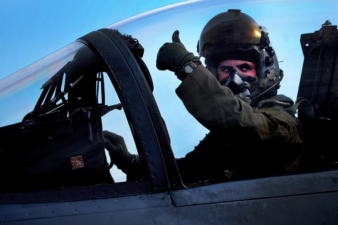 A pilot from the 493rd Expeditionary Fighter Squadron signals that he is good-to-go to his wingman prior to a sortie at Siauliai Air Base, Lithuania, Aug. 31, 2017. The 493rd EFS will conduct routine patrols in the Baltic region for the next 120 days, maintaining a constant vigil over the sovereign airspace of Lithuania, Latvia and Estonia. (U.S. Air Force photo/ Tech. Sgt. Matthew Plew)