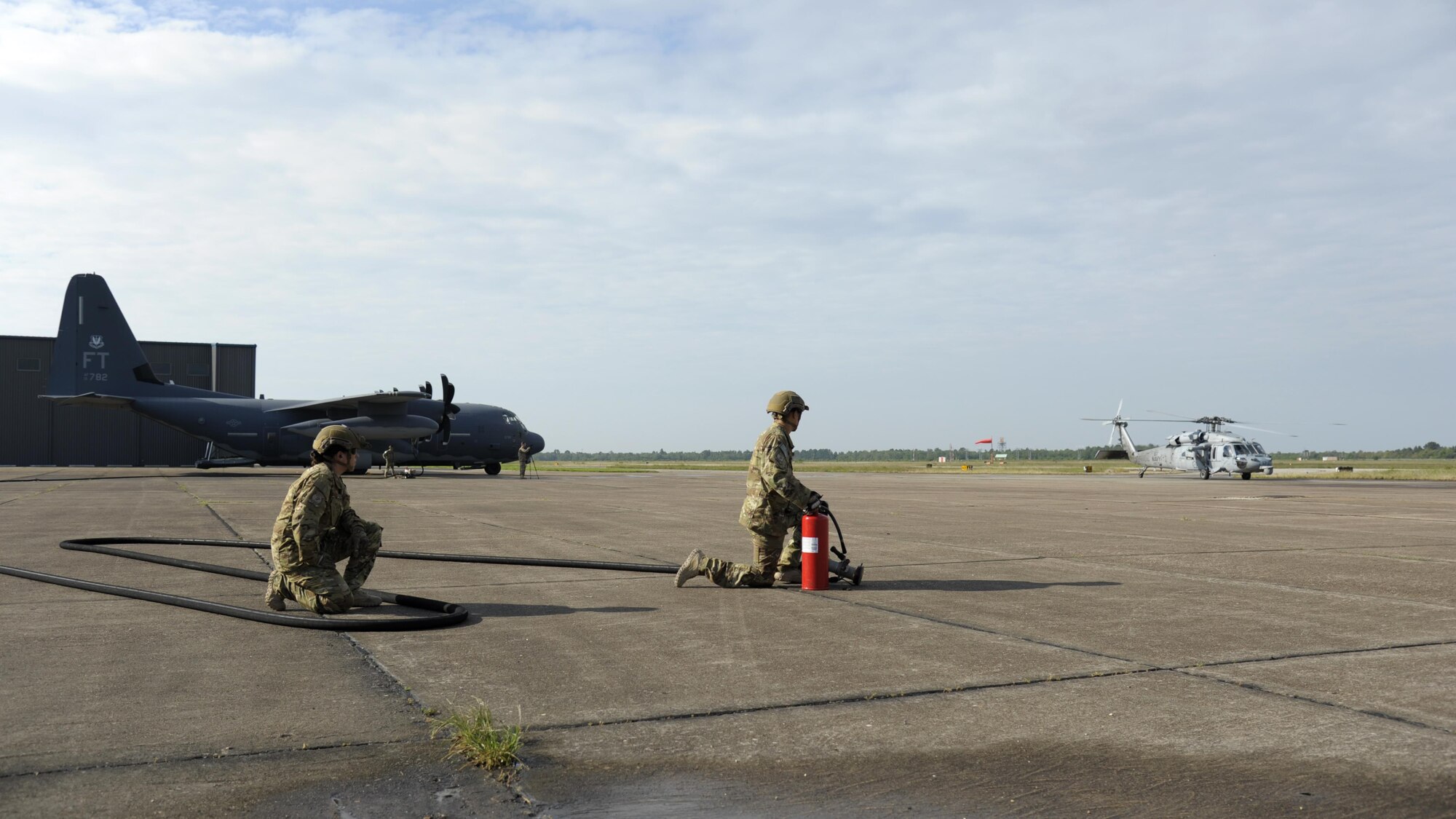 Members from the 23d Logistics Readiness Squadron forward area refueling point (FARP) team prepare to refuel a MH-60S Seahawk from the USS Dwight D. Eisenhower Aug. 31, 3017, at Jack Brooks Regional Airport in Beaumont, Texas.