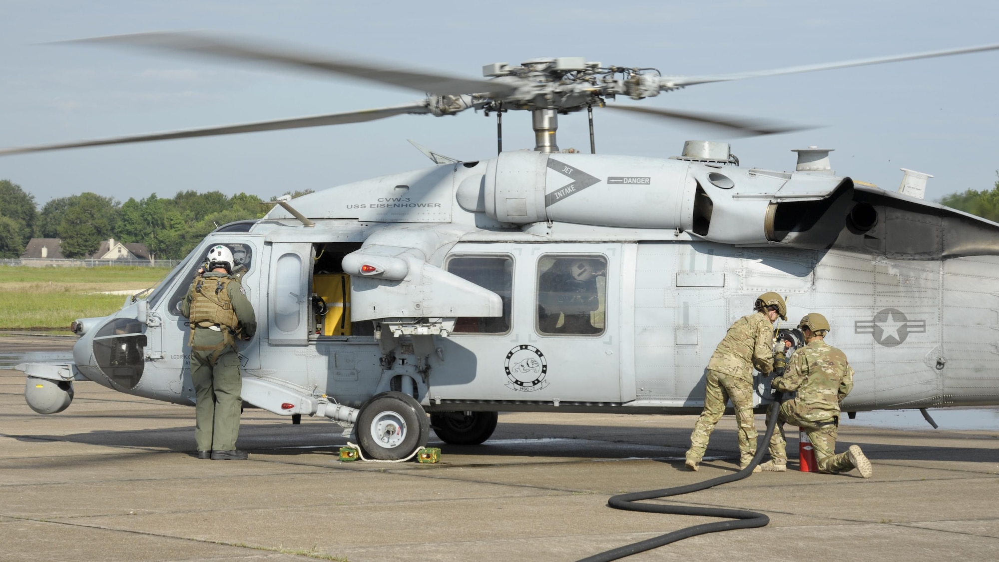 Members from the 23d Logistics Readiness Squadron forward area refueling point (FARP) team conduct a hot refuel of a MH-60S Seahawk from the USS Dwight D. Eisenhower Aug. 31, 3017, at Jack Brooks Regional Airport in Beaumont, Texas.