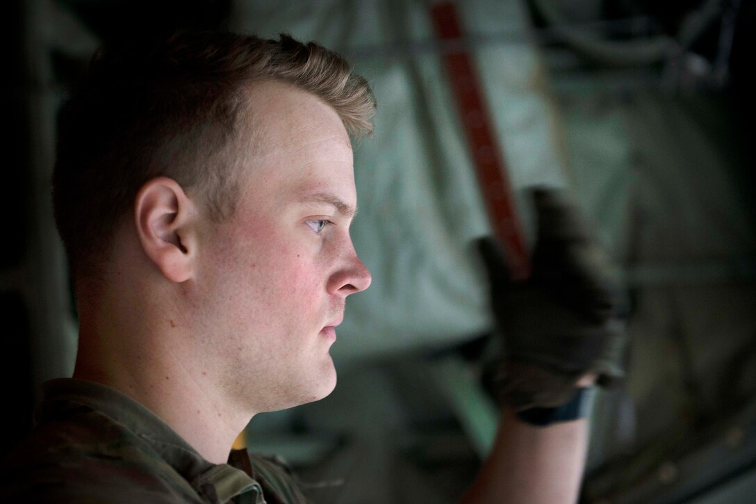 Air Force Senior Airman Jacob Snider directs a k-loader at Bagram Airfield