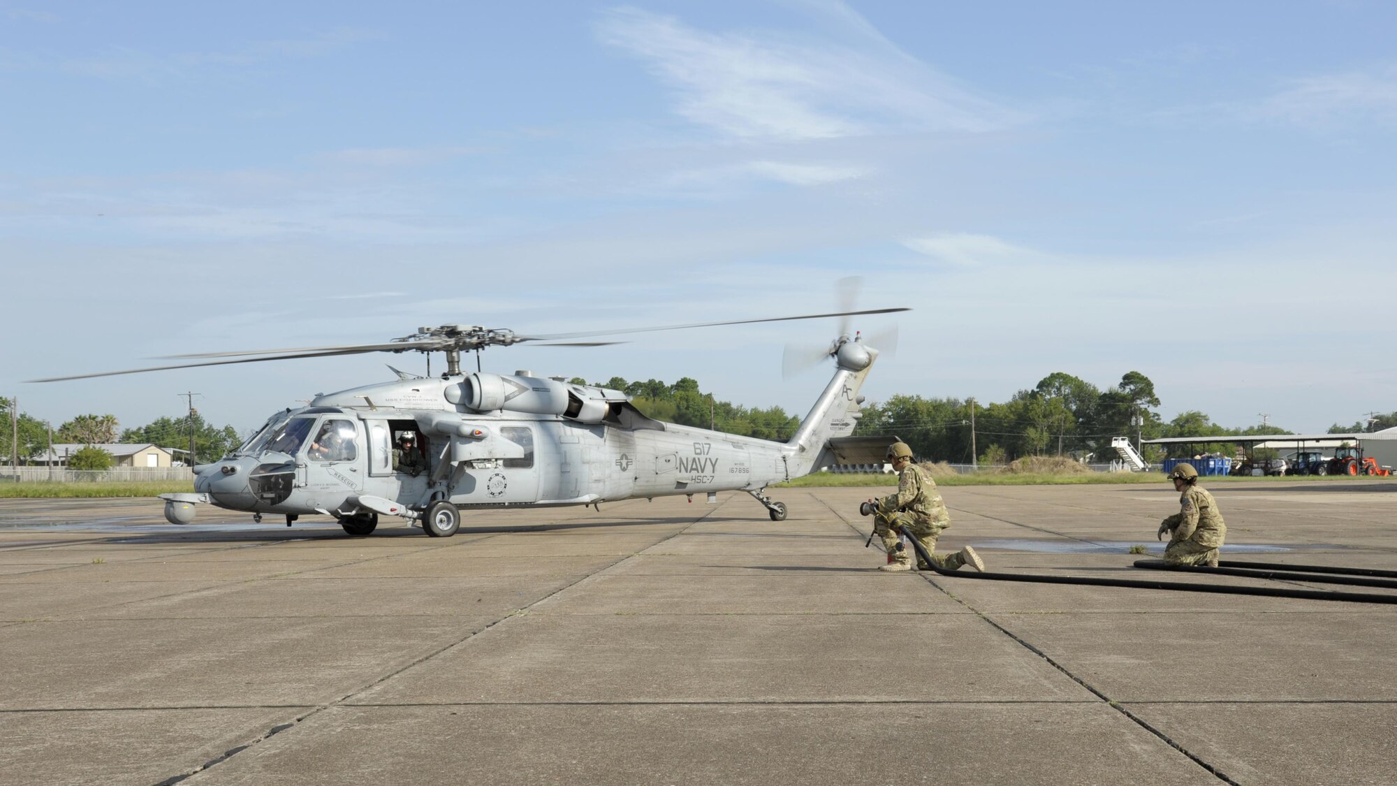 Members from the 23d Logistics Readiness Squadron forward area refueling point (FARP) team prepare to refuel a MH-60S Seahawk from the USS Dwight D. Eisenhower Aug. 31, 3017, at Jack Brooks Regional Airport in Beaumont, Texas.