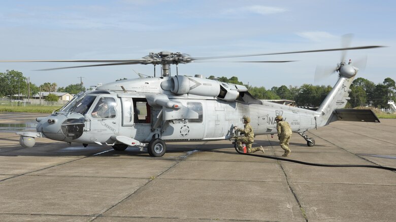 Members from the 23d Logistics Readiness Squadron forward area refueling point (FARP) team prepare to refuel a MH-60S Seahawk from the USS Dwight D. Eisenhower Aug. 31, 3017, at Jack Brooks Regional Airport in Beaumont, Texas.